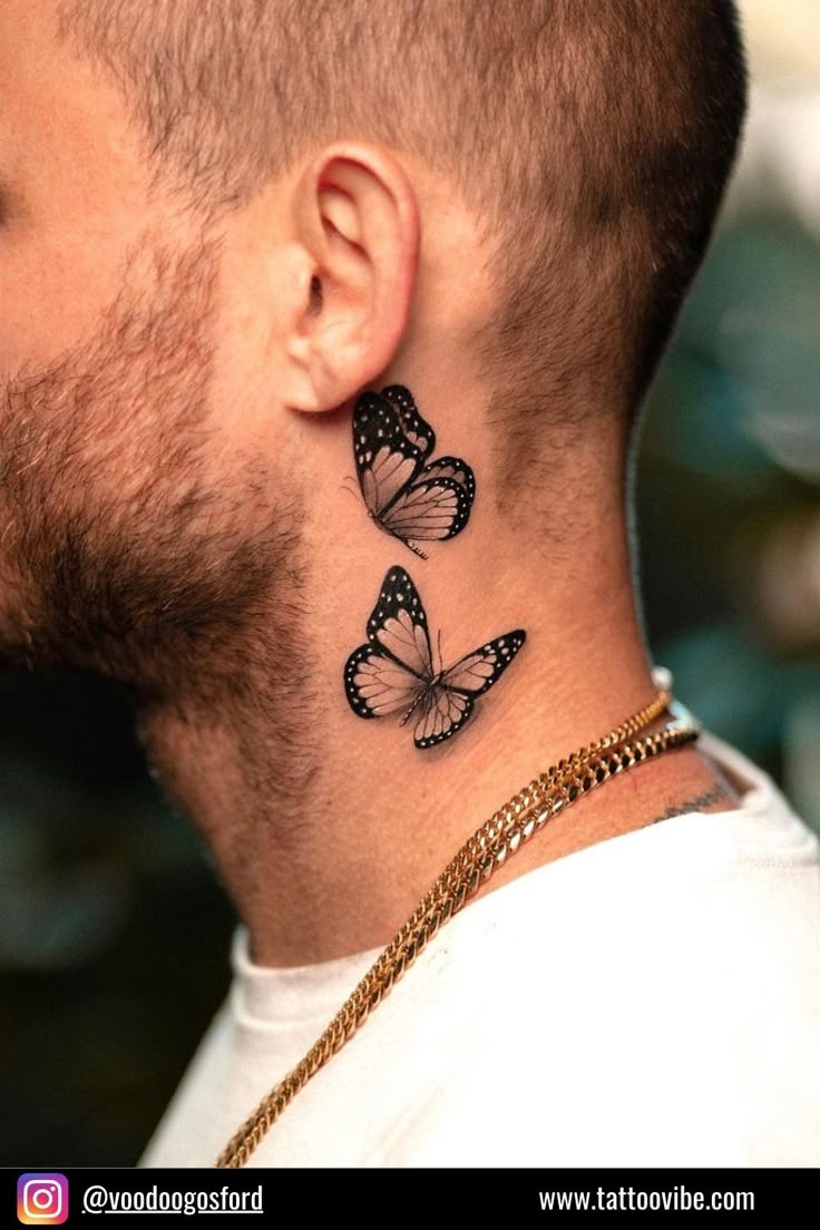 A Tattoo Of Two Butterflies On A Man